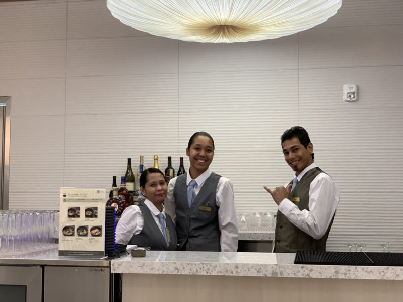 a group of people standing behind a counter
