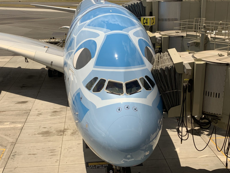 a blue airplane with a face painted on it