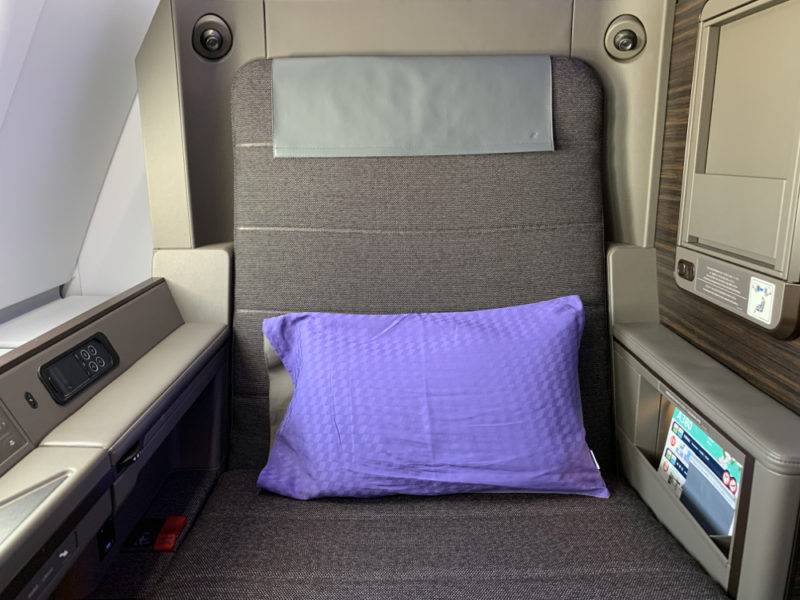 a seat with a purple pillow