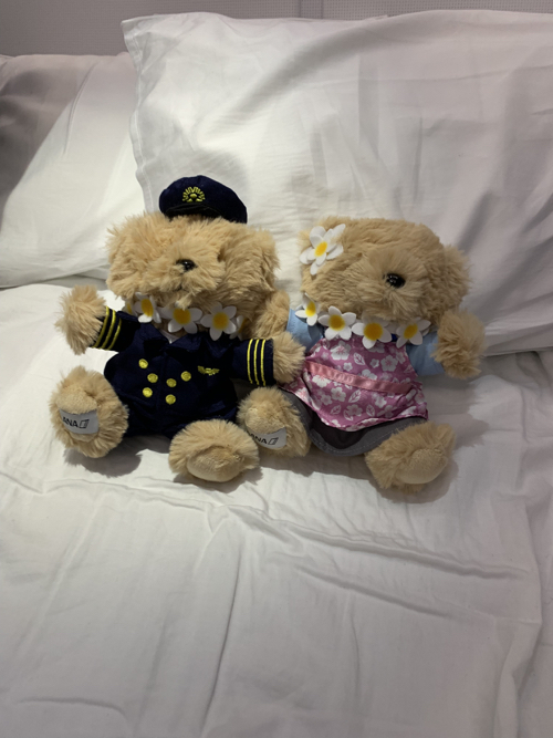 two stuffed bears on a bed