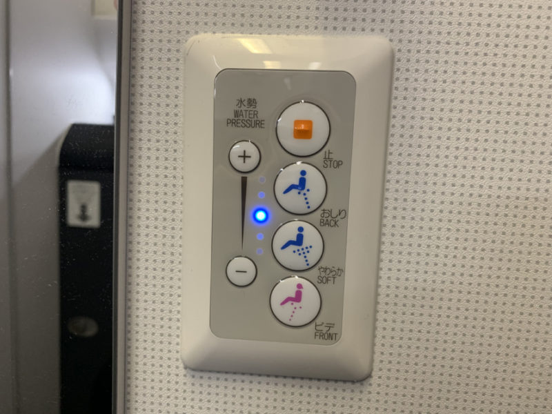 a white panel with buttons and blue lights