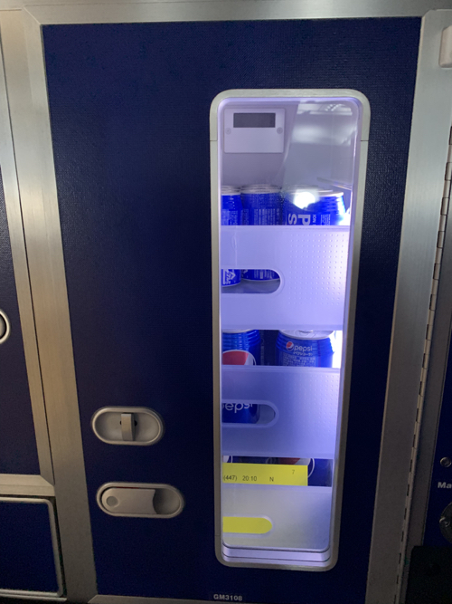 a vending machine with cans of soda