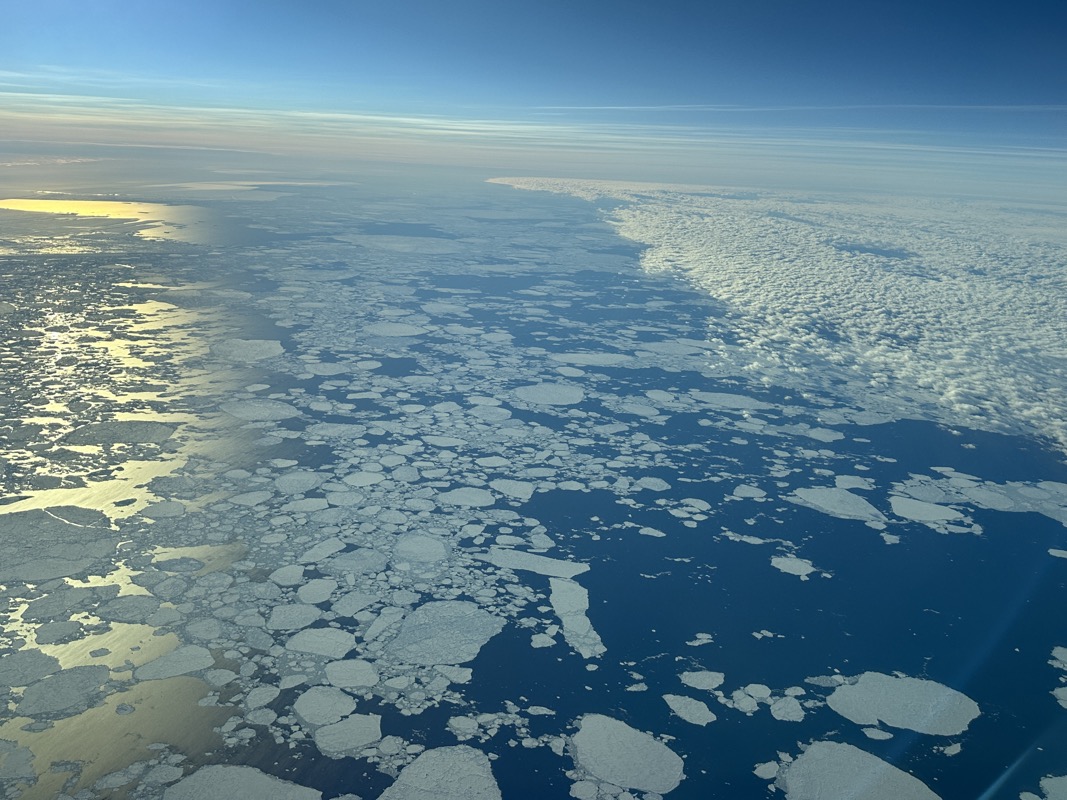 an aerial view of icebergs in the ocean