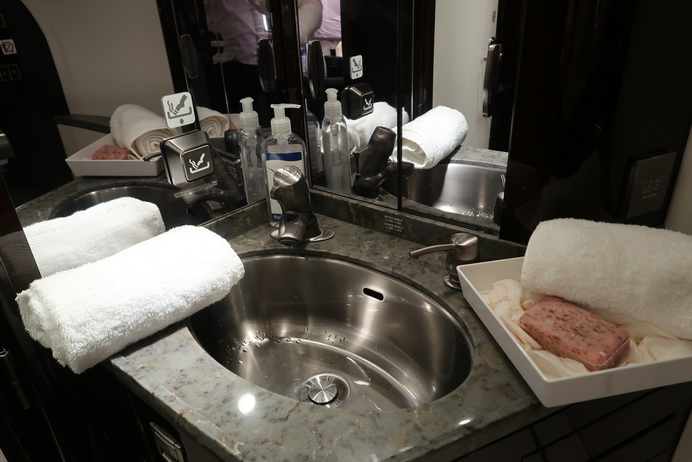 a sink with towels and soap on it