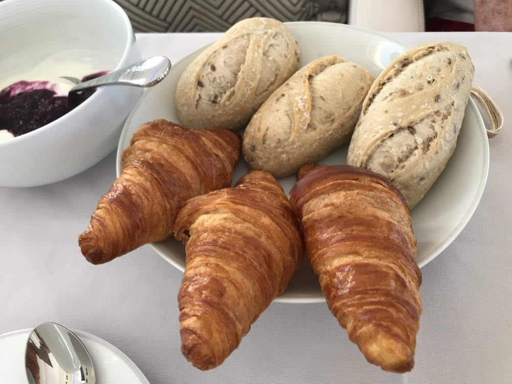 a plate of croissants and bread