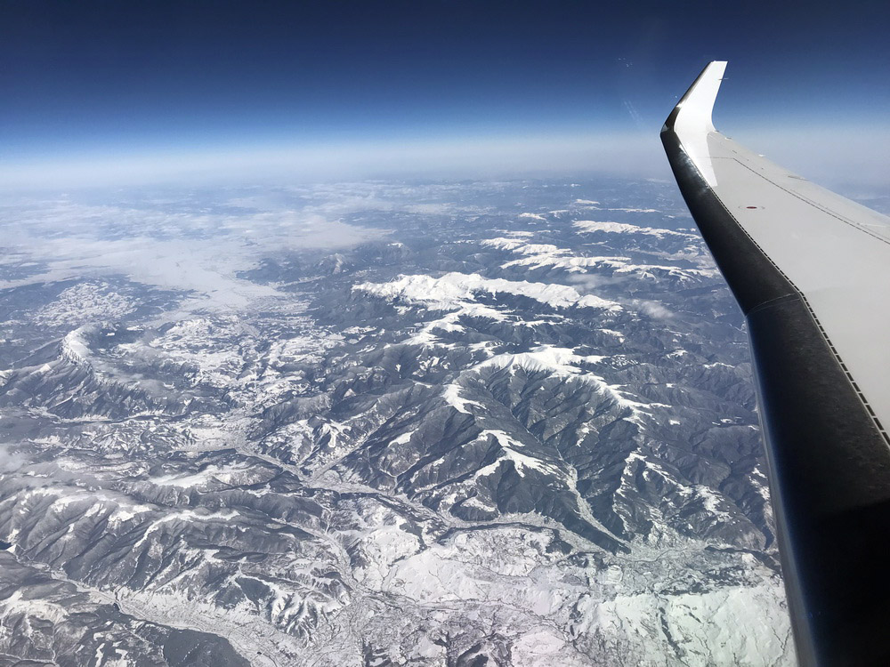 an airplane wing and mountains