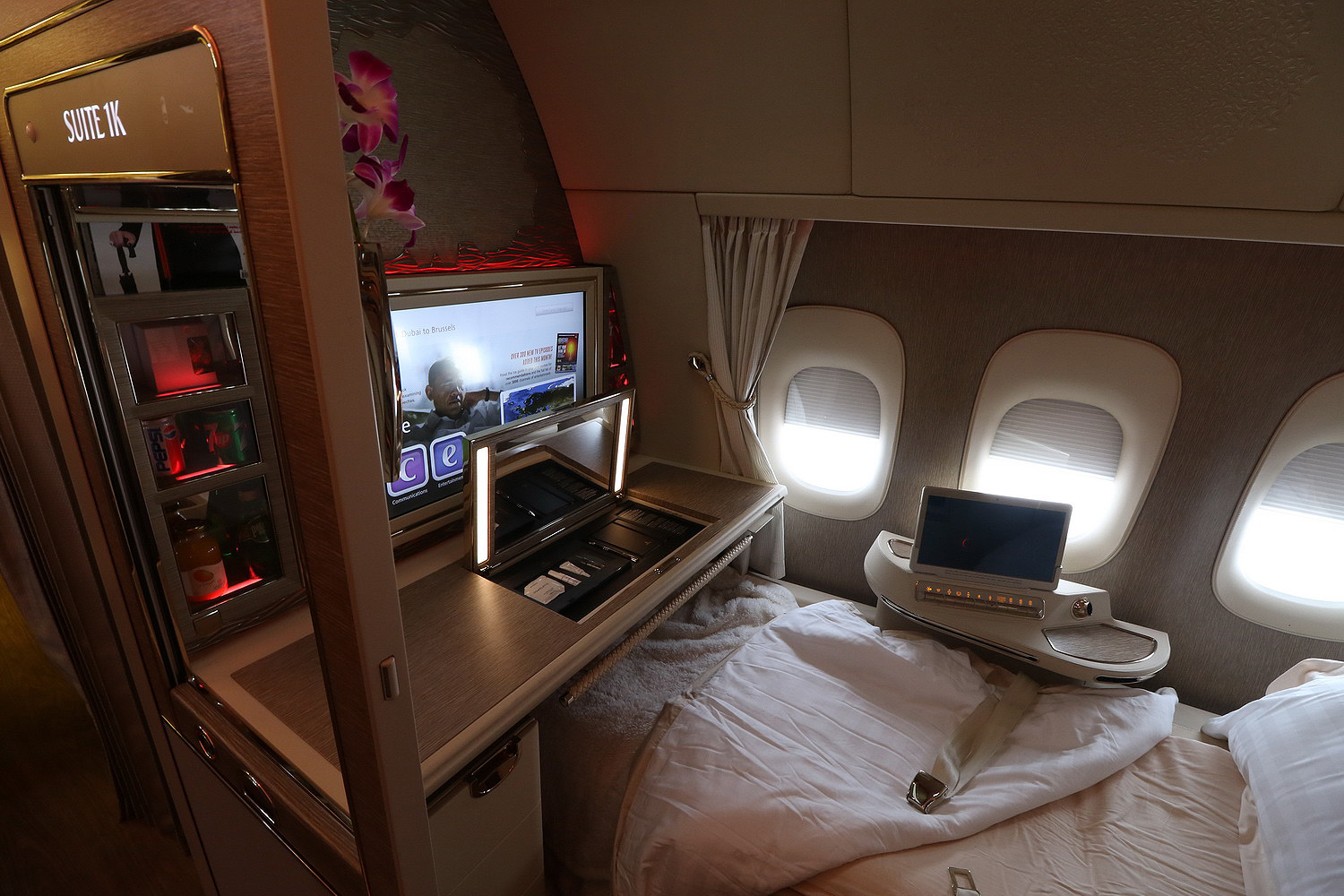 a bed with a laptop and a computer on it