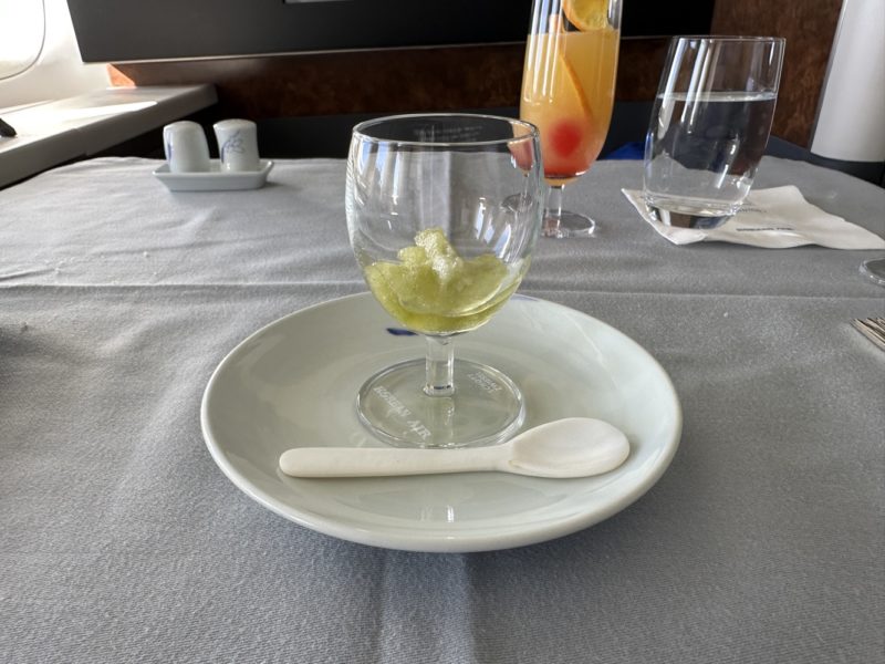 a plate with a glass of liquid on it