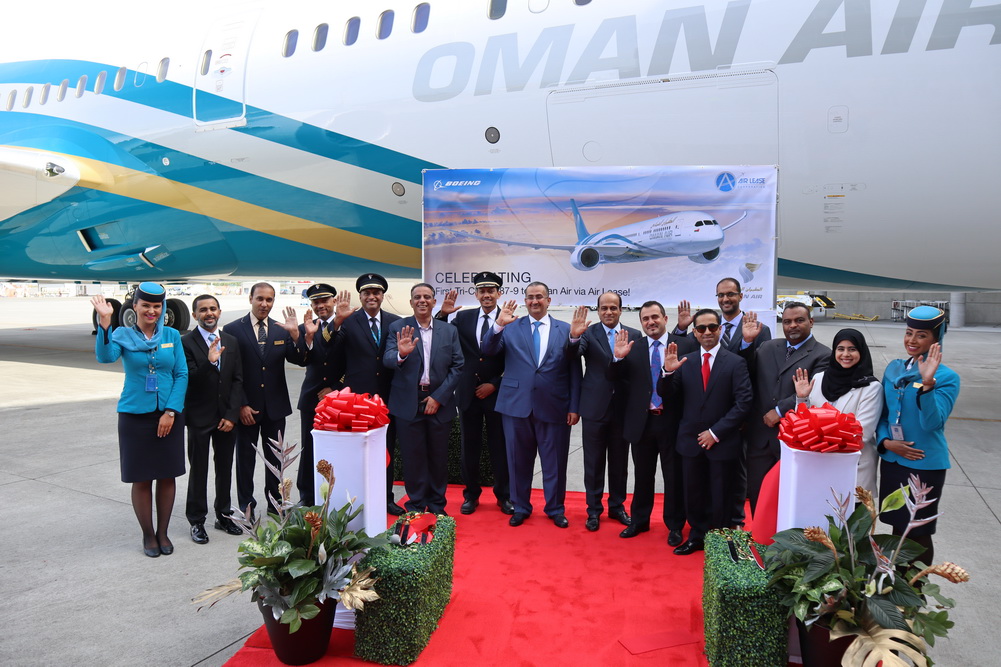 a group of people in suits standing in front of a plane