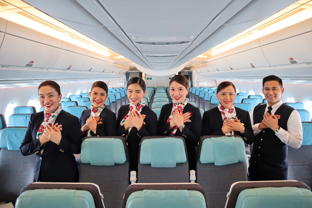 a group of women in black uniforms in an airplane