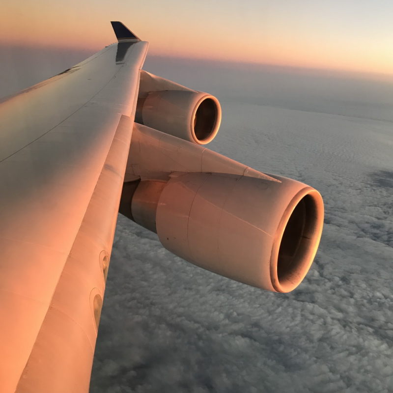 an airplane wing with the sky in the background