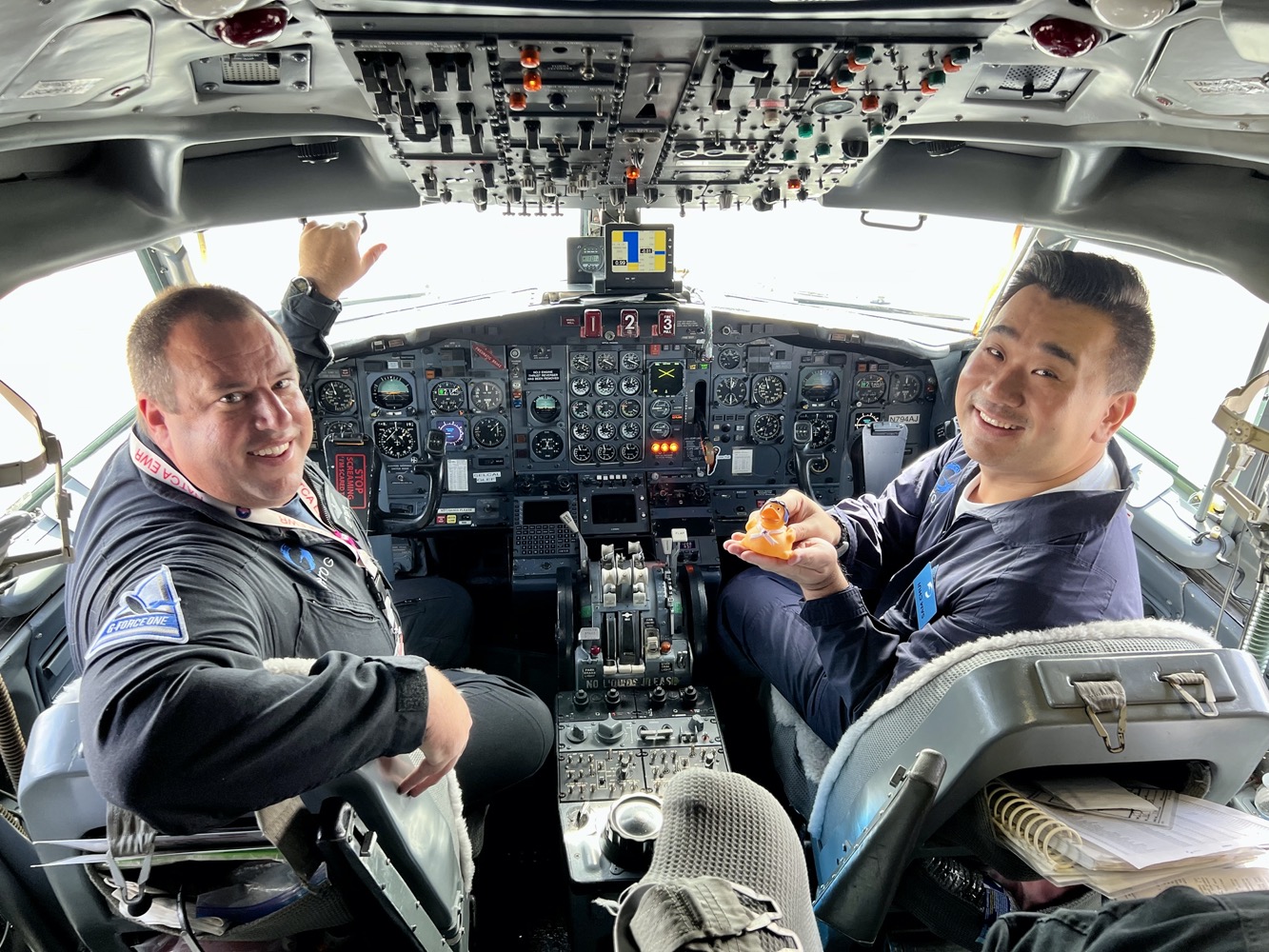 two men sitting in a cockpit of an airplane