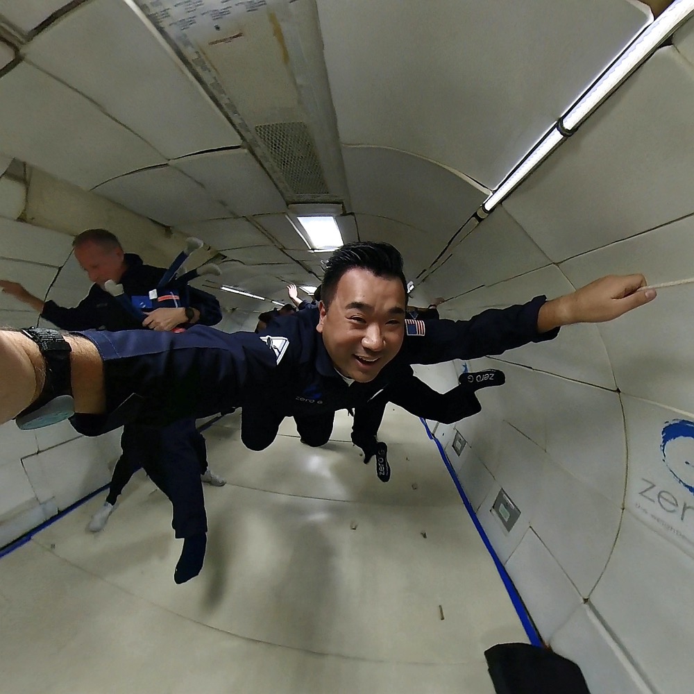 a man in a suit flying in a tunnel